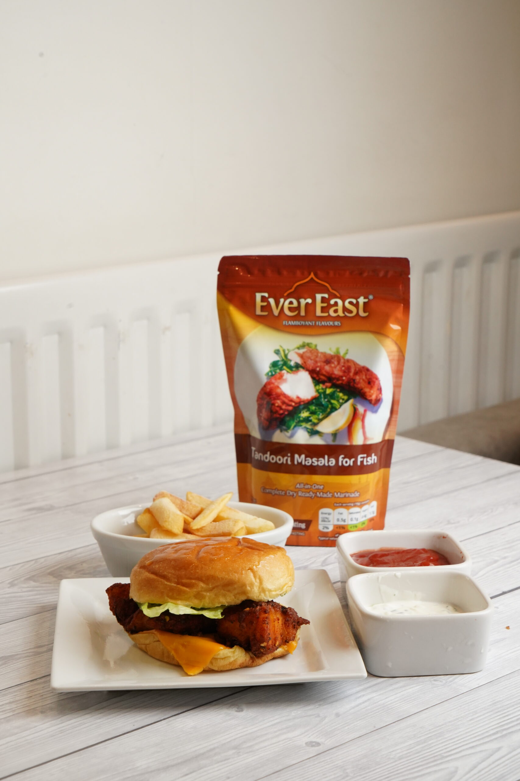 Ever East tandoori fish tray bake with flaky masala fish, roasted vegetables and lemon for